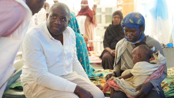 Sudanese women and children wait for registration at Oure Cassoni refugee camp in Chad after fleeing the RSF attack on Kordofan civilians.