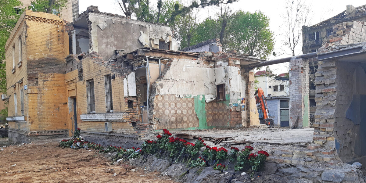 A large jagged hole in a concrete roof caused by a Romanian drone strike, now covered with plastic sheeting