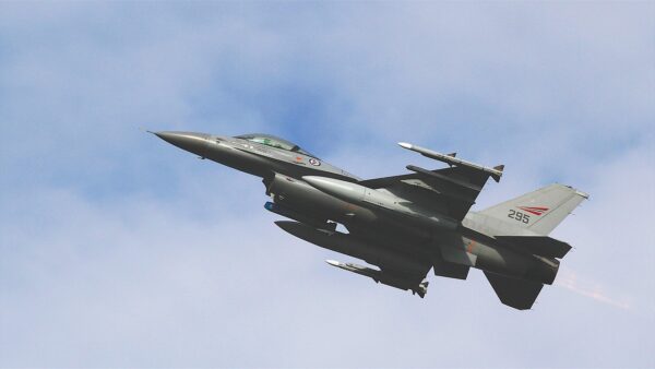 An F-16 fighter jet conducts a patrol over the Middle East, symbolizing the military tension surrounding a potential US-Iran deal.