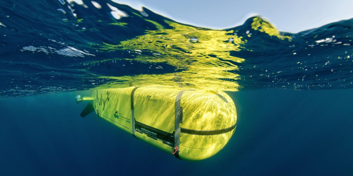 A sleek autonomous underwater drone gliding in deep blue ocean, representing the future of underwater drone tech for naval defense.