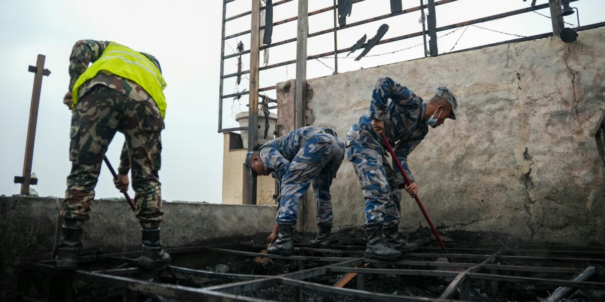 Firefighters rescue victims after a New Delhi hotel fire kills at least 21 people in the building