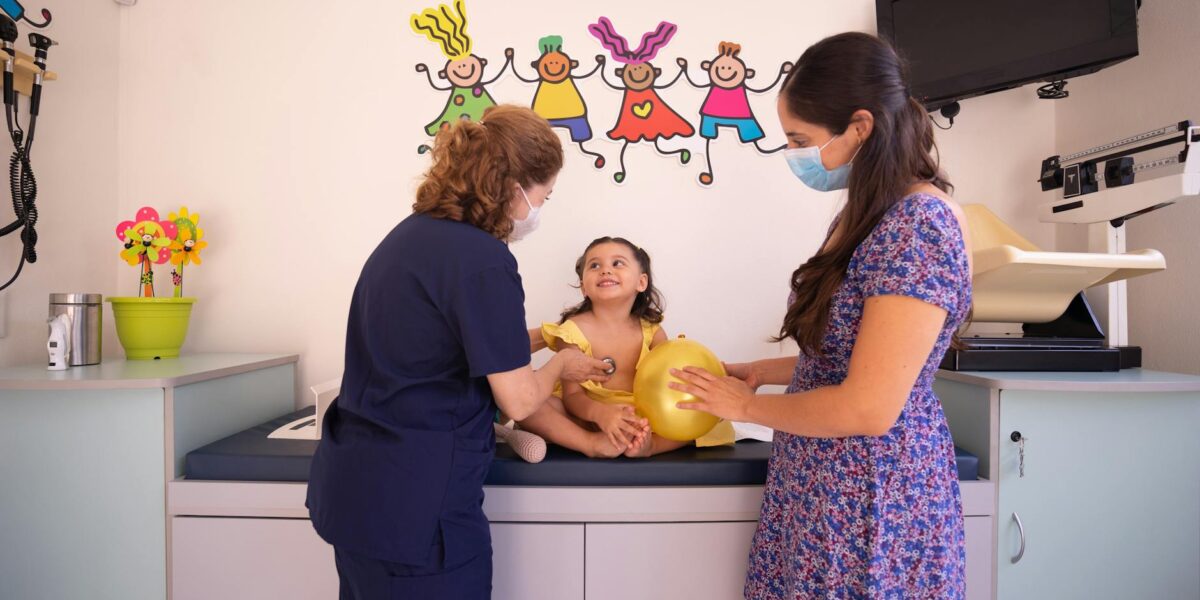 Two young kids sitting in a clinic waiting room, one looks worried, representing the growing children's mental health waiting list