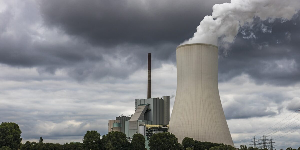 Smokestacks from a coal power plant in China with hazy sky, illustrating China carbon emissions data